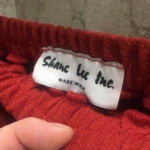 At an angle Rust Ruffled skirt